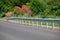 red road reflectors along the road. metal road fencing of barrier type, close-up. Road and traffic safety. reflective