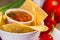 Red roasted tomato salsa with corn chips.