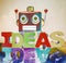 Red robot head on wooden letters that say IDEAS