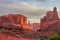 Red rock spires below a cloudy sky in Arches National Park.