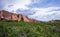 Red rocks in the green park with clouds