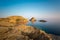 Red rocks and lighthouse of Ile Rousse in Corsica