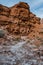 Red Rocks Sit Above White Mineral Covered Wash