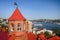 Red roof of brick building, port Vladivostok, panorama of Zolotoy rog bayl, Russia