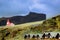 Red roof church on the hill, with summer cottages in the foreground, Vik i Myral, Iceland