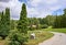 Red roof of the house amid green trees