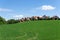 Red roofed houses on a green hill