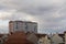 Red roofs and pink apartment building. Prefabricated house. Windows, balconies, roofs and chimneys