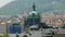 Red roofs tops and dome of ancient church under reconstruction in sunny day