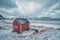 Red rorbu house shed on beach of fjord, Norway