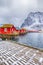 Red Rorbu Houses of Sakrisoy Village with Snow in Winter.