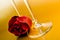 Red rose arranged near wineglass