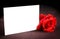 Red rose and blank gift card for text on old wood background