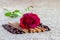 Red rose, cinnamon, coffee beans on a brown background