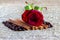 Red rose, cinnamon, coffee beans on a brown background