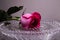 Red rose on a crystal tray with water droplets. Flower of love.