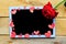 Red rose and decorative hearts on the mockup tablet. Valentine`s Day, Wedding or Mother`s Day greeting card.