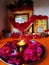 Red rose flowers over yellow background with diwali diya kept in the middle.