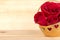 Red rose in gold basket, Valentines Day, wedding day, wood background.