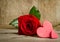 Red rose with handemade valentines on wooden background