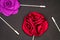 Red Rose Men`s Lapel Pin on black textured matt Isolated