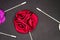 Red Rose Men`s Lapel Pin on black textured matt Isolated