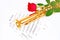 Red rose, saxophone and music sheet