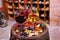 Red, rose and white glasses and bottles of wine. Grape, fig, nuts and leaves on old wooden barrel.