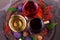 Red, rose and white glasses of wine. Grape, fig, nuts and leaves on old wooden barrel. View from above, top studio shot.