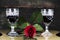 Red Rose and Wine Glasses Resting On Acoustic Guitar With Sign L