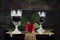 Red Rose and Wine Glasses Resting On Acoustic Guitar With Sign L
