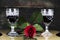 Red Rose and Wine Glasses Resting On Acoustic Guitar With Sign R