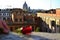 Red Rose and women hand with Rome City Background. Photo from top of the spanish steps