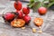 Red rosehips and cut berries in half with seeds on a wooden table