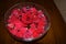 Red Rosepetals In Water filled Bowl