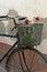 Red roses in basket of old rusty bicycle
