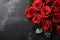 Red roses bouquet on dark stone background
