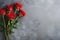 Red roses bouquet on dark stone background