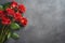 Red roses bouquet on dark stone background