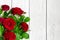 Red roses bouquet over white wooden table. valentines day or womens day background