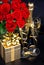 Red roses, champagne and golden gift. Festive decoration