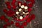 Red roses and chocolate pralines in heart shaped gift box