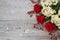 Red roses, hydrangea, hips on wooden background