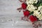 Red roses, hydrangea, hips on wooden background