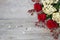 Red roses, hydrangea, hips on wooden background