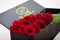 Red roses in an original box to his beloved woman