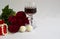 Red roses, pearl beads, glass of red wine, sweets