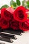 Red roses piano keys romantic background.