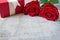 Red roses with red gift box on woonden.Valentine\'s Day.