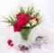 Red roses in vase and vintage teacups